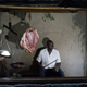 Mugerwa Lawrence in the small shop where he sells meat until 1am in Kalagala, Uganda.